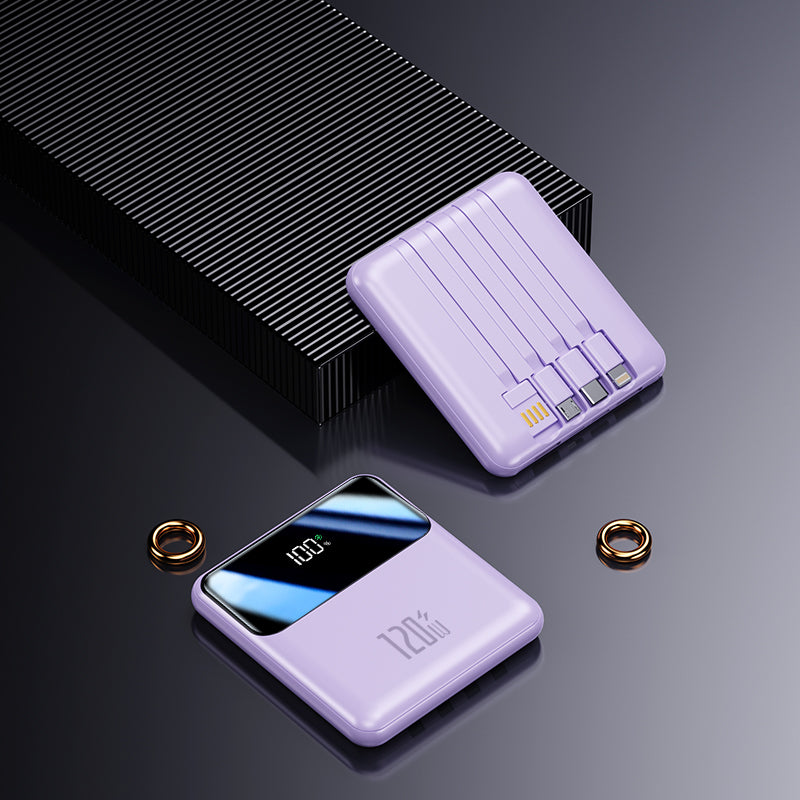 The image shows a purple potable power bank with three charging cables and a USB cable to connect directly to the socket or charging head, a digital screen and a looped strap for easy carrying.