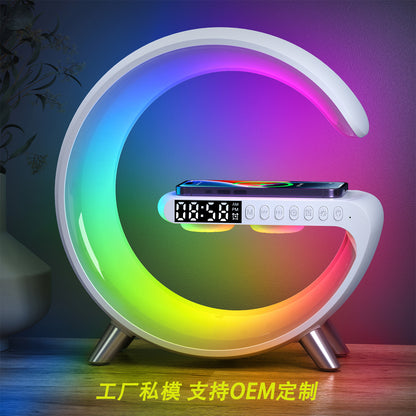 The image features a stylish, modern device that combines the functions of an alarm clock, a wireless charger, and a colorful LED lamp, creating a multifunctional and aesthetically pleasing product.
