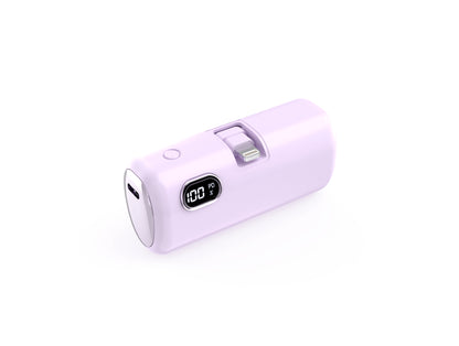 The picture shows a light purple portable power bank with a built - in PD port and a digital display indicating 100% battery charge.
