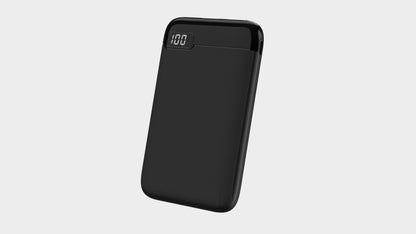 The picture shows a black portable power bank , displaying "100" on its digital screen, indicating it is fully charged.
