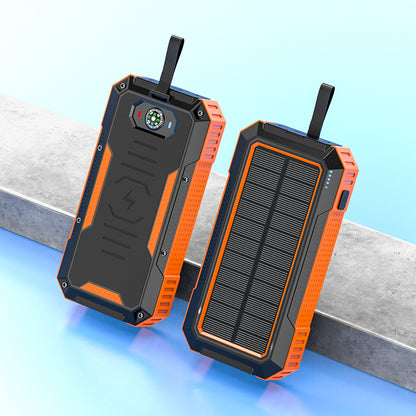 Pictured are two sturdy, portable orange solar power banks with a solar panel on one side and a built-in compass and indicator light on the other.