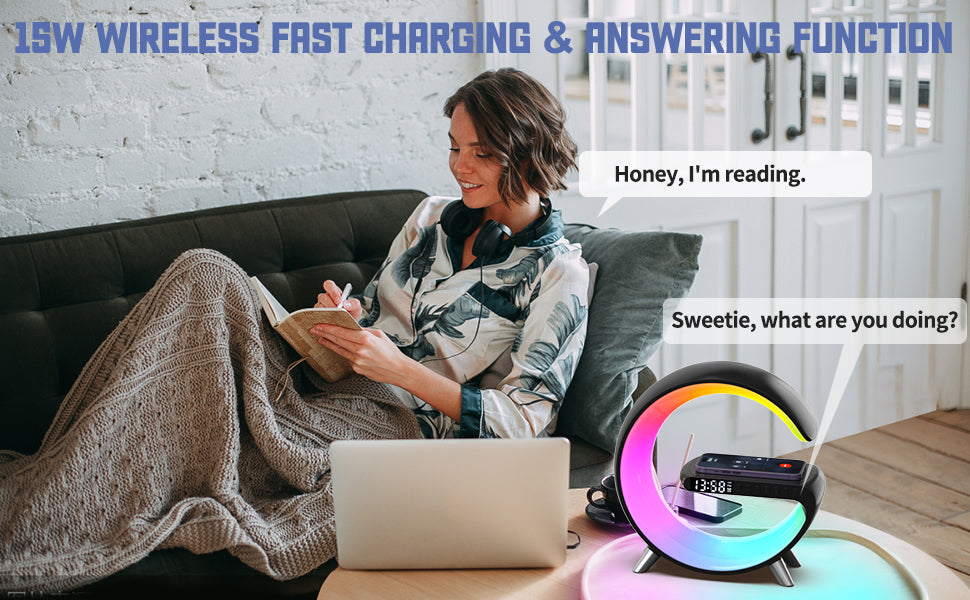 The picture shows a woman reading while an alarm clock and smart lamp with 15W wireless fast charging and answering function is on a table.
