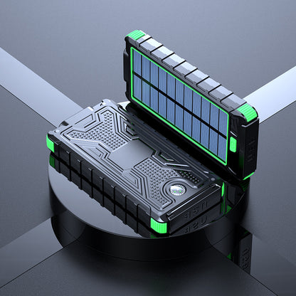 The image shows a green portable solar power bank with a solar panel on the lid. It has a sturdy black and blue design with multiple charging ports and an on/off switch on the main unit.