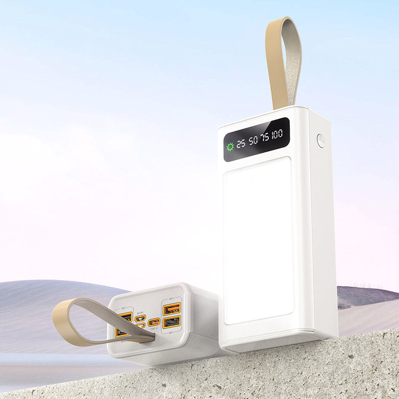 The picture shows a white mobile power bank with a digital display and multiple charging ports on one side and a built-in flashlight on the other side.