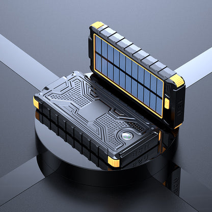 The image shows a yellow portable solar power bank with a solar panel on the lid. It has a sturdy black and blue design with multiple charging ports and an on/off switch on the main unit.