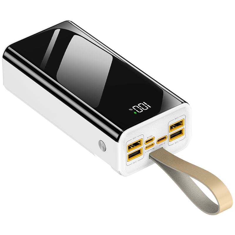 The picture shows a portable power bank with a sleek black and white design, featuring a digital display showing "100", multiple USB ports, and an attached wrist strap.
