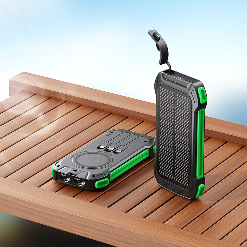 The picture shows two portable power banks with rugged designs and green accents, one with a solar panel and both equipped with multiple charging ports.
