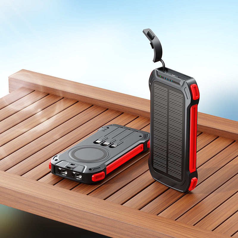 The picture shows two portable power banks with rugged designs and red accents, one with a solar panel and both equipped with multiple charging ports.
