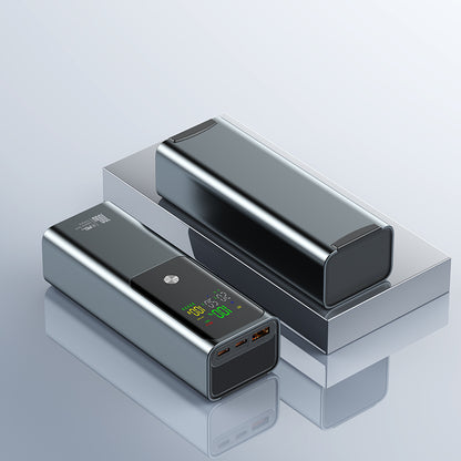 The image shows two grey power banks with a very digital display, 100W capacity and the way of output can meet the multiple needs for your devise.