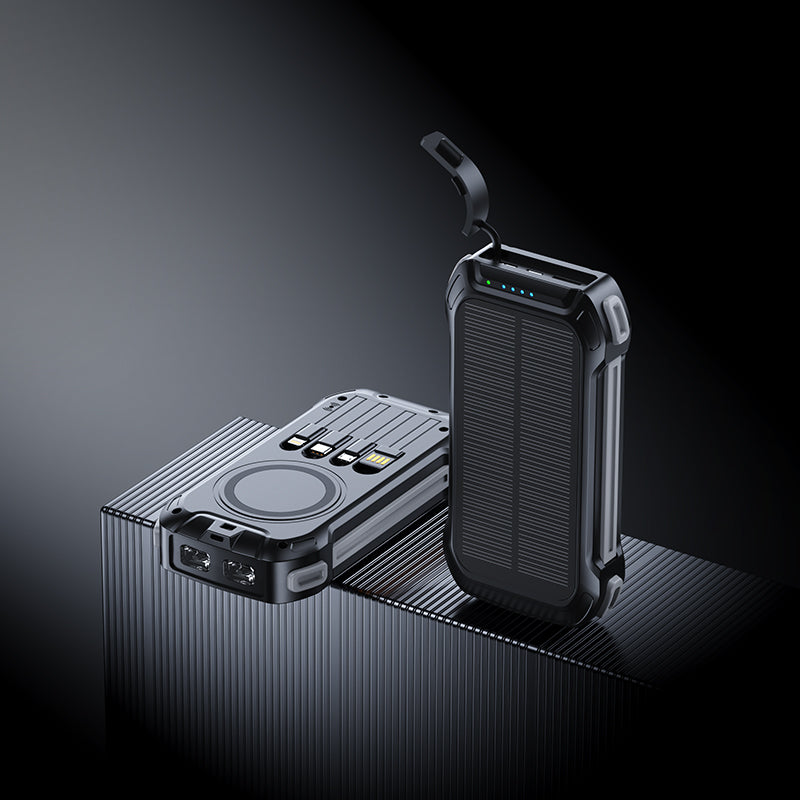 The picture shows two portable power banks with black accents; one has a wireless charging area, multiple ports, and a solar panel, while the other features a similar design with a handle.
