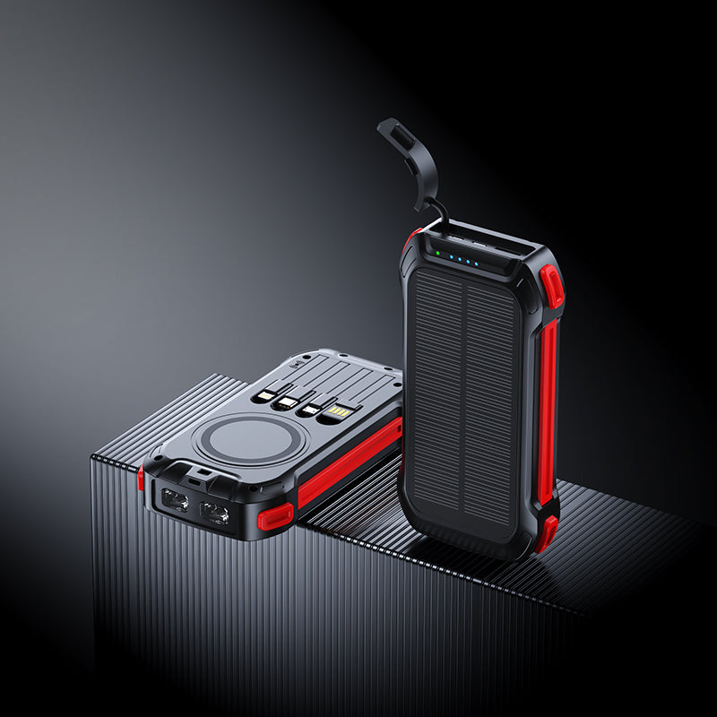 The picture shows two portable power banks with red accents; one has a wireless charging area, multiple ports, and a solar panel, while the other features a similar design with a handle.
