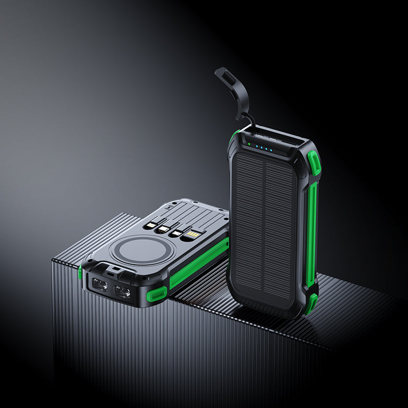 The picture shows two portable power banks with green accents; one has a wireless charging area, multiple ports, and a solar panel, while the other features a similar design with a handle.
