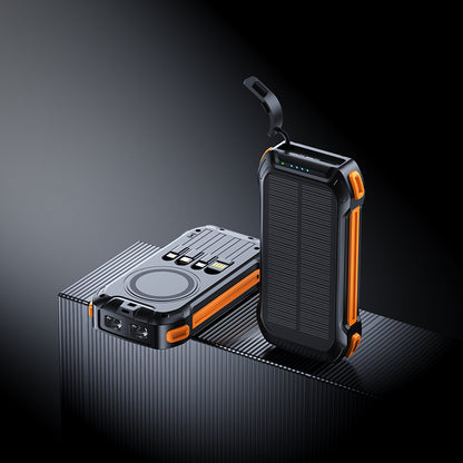 The picture shows two portable power banks with orange accents; one has a wireless charging area, multiple ports, and a solar panel, while the other features a similar design with a handle.
