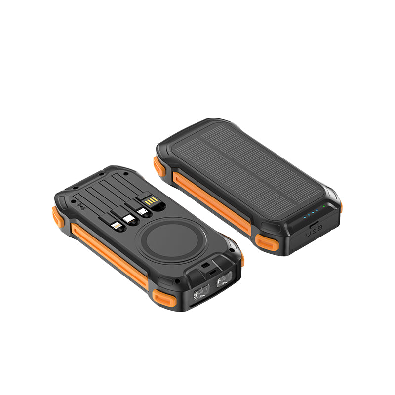 The picture shows two rugged - looking power banks with orange accents; one has a solar panel on the top for charging, while the other features multiple ports including USB and a wireless charging pad on the front.
