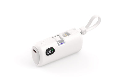 The picture shows a white portable power bank with a digital display showing 100% power, featuring a wrist strap and multiple charging ports.
