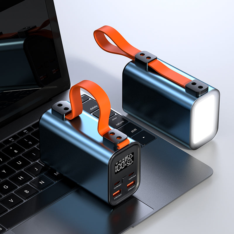 The picture shows two portable power banks with orange straps; one has a digital display showing "100:50" and multiple ports, while the other has a bright light on the side.
