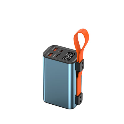 The picture shows a portable power bank with a metallic blue body, an orange strap, multiple charging ports, and a digital display showing "100:50".
