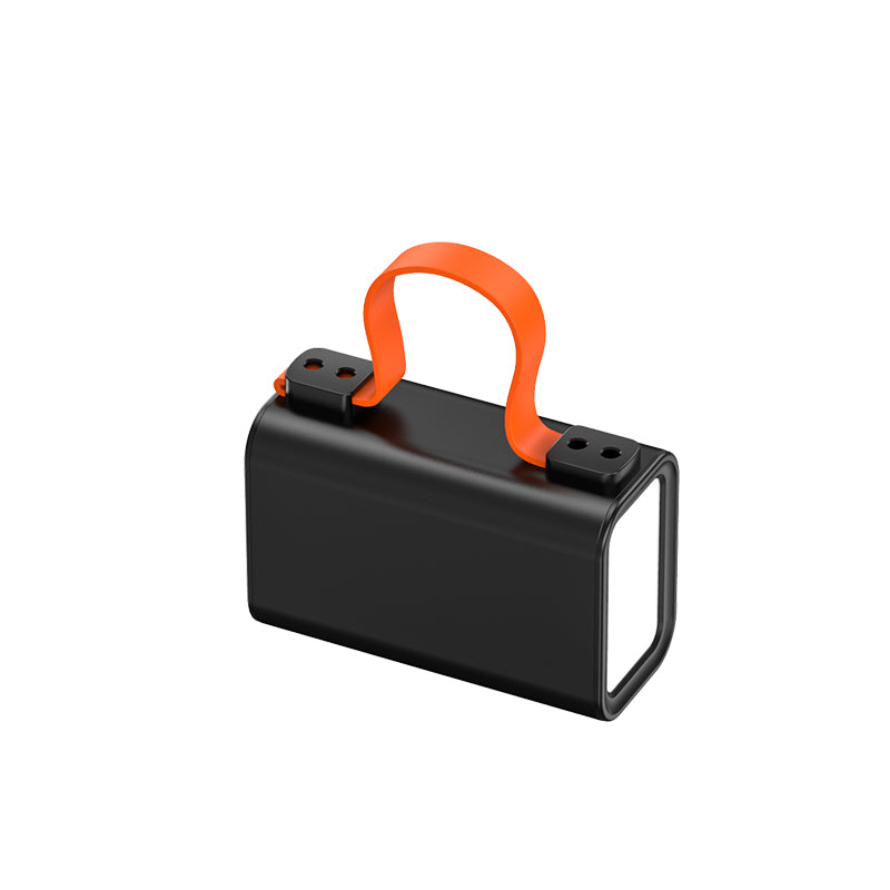 The picture shows a black mobile power bank with an orange handle on the top and a light on one side.