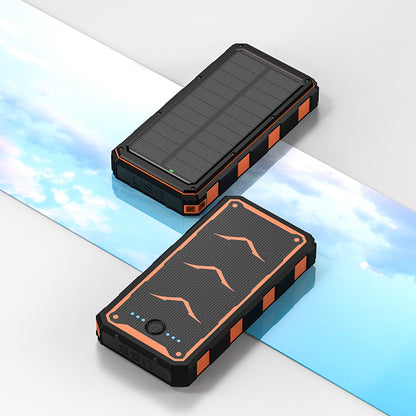 The picture shows two portable power banks with solar panels on top, featuring rugged designs with black and orange colors, and equipped with USB ports for charging.
