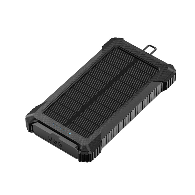 The picture shows a portable power bank with a solar panel on the top surface, featuring a rugged design with  black color, and having a USB port on the side.
