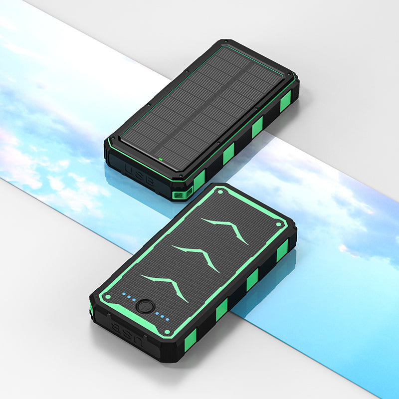 The picture shows two portable power banks with solar panels on top, featuring rugged designs with black and green colors, and equipped with USB ports for charging.
