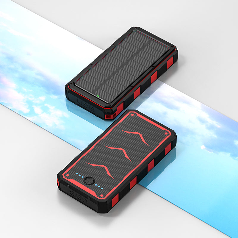 The picture shows two portable power banks with solar panels on top, featuring rugged designs with black and red colors, and equipped with USB ports for charging.
