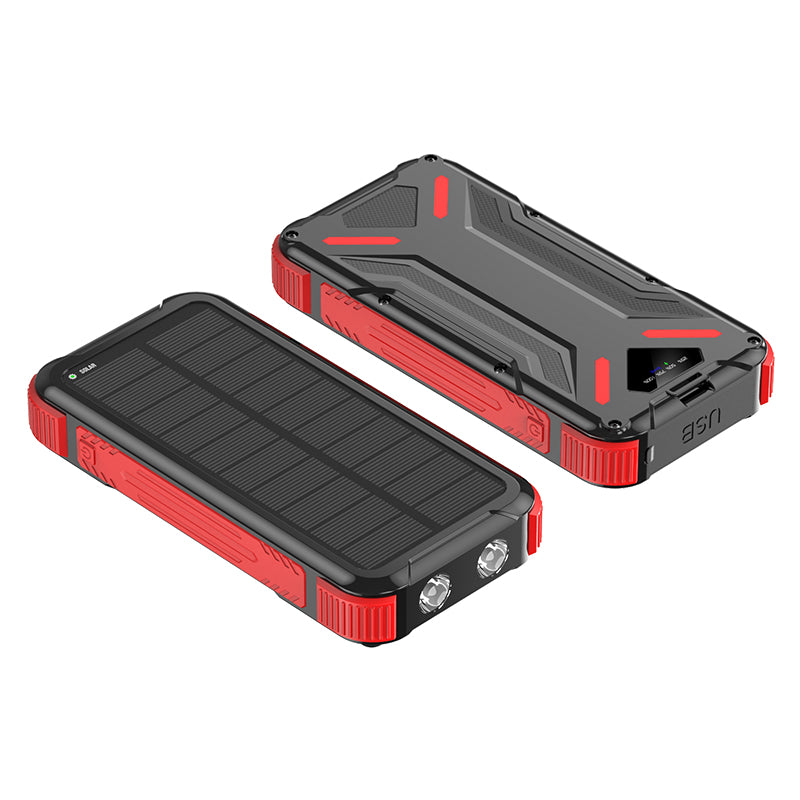 The picture shows a portable red solar power bank with a rugged design, featuring solar panels on one side and multiple ports for charging on the other.
