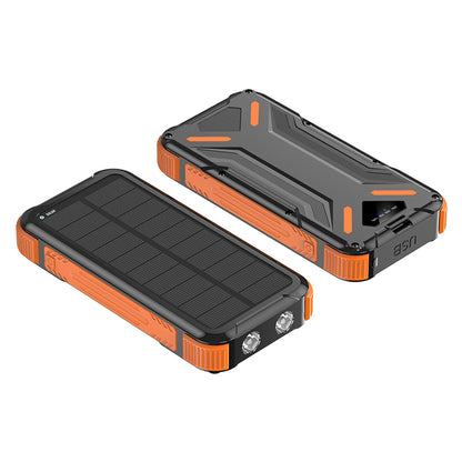 The picture shows a portable orange solar power bank with a rugged design, featuring solar panels on one side and multiple ports for charging on the other.